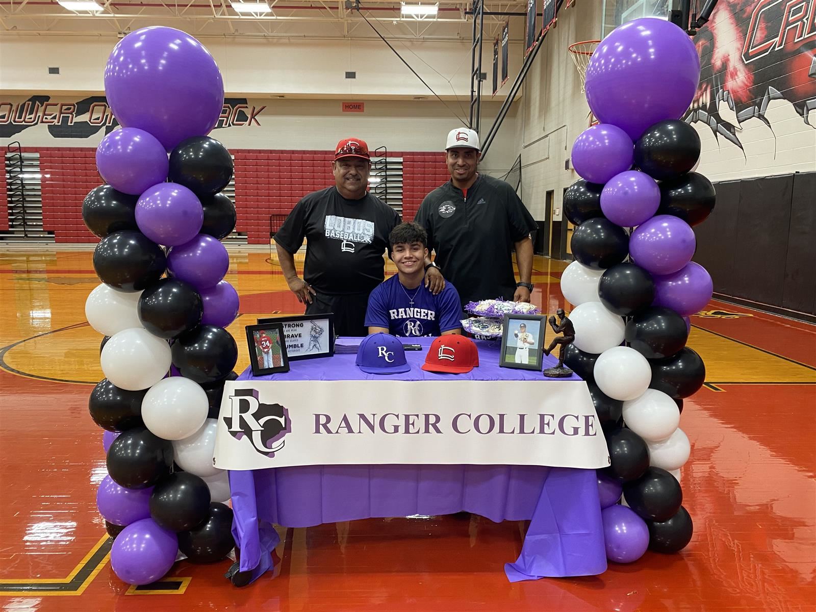 Langham Creek High School senior Sergio Soto, seated, signed a letter of intent to play baseball at Ranger College.